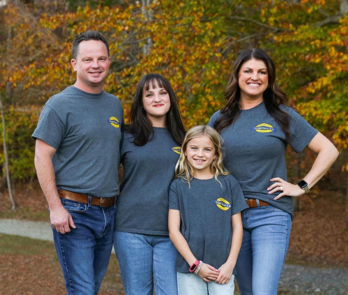 Original Triad Door Company technicians working on a garage door