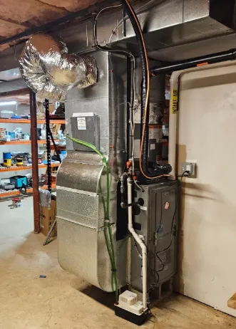McClaren Heating & Air Conditioning technician on a South Shore service call